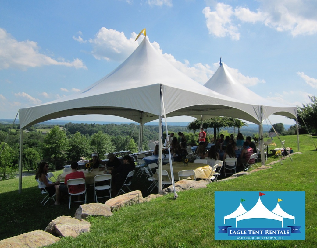 Photo of tent overlooking scenic background with Eagle Tent Rentals logo